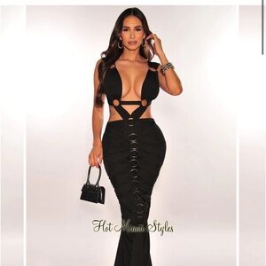 Indulge in the unexpected with the Black Ribbed Cut Out O-Ring Pleated Gown.
